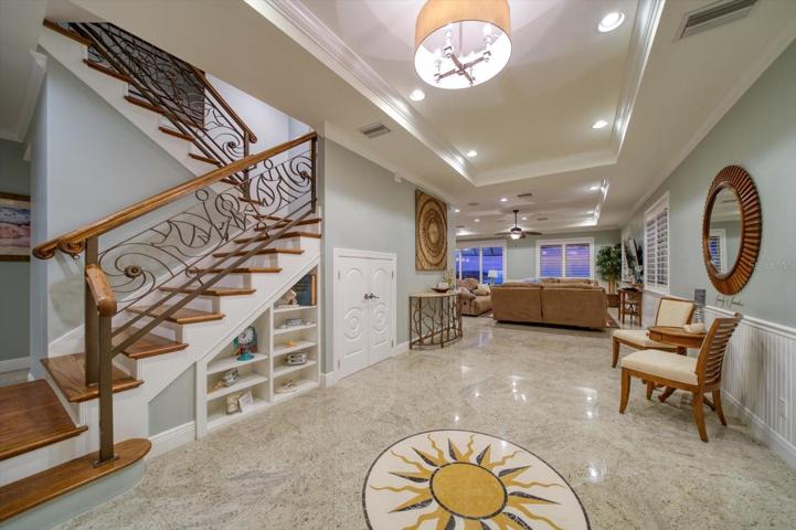Hand crafted, custom designed railings, granite flooring throughout. Tasteful built-ins, plantation shutters, quality crafted coiffured ceilings, and a fabulous floor plan..