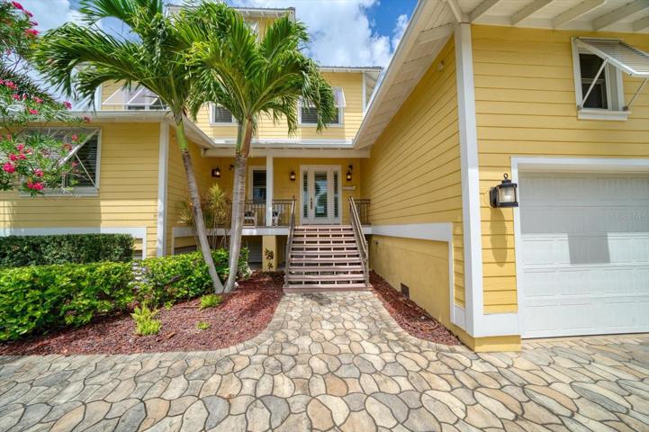 Customized tri-level residence with multiple terraces, wrap around lower deck, paved walk-ways, beautifully landscaped, gorgeous pool, and private beach frontage!
