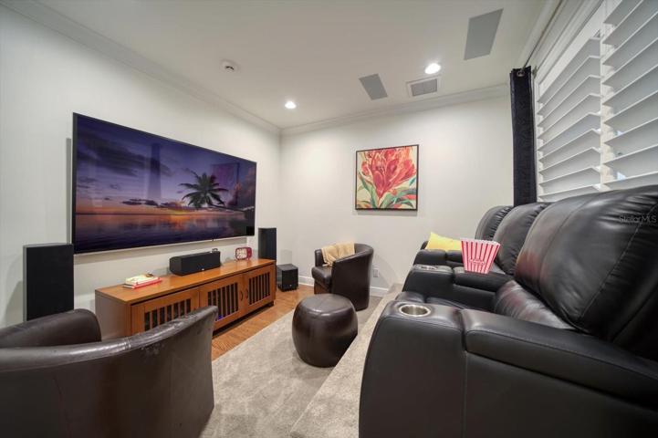 Media room, perfect for entertaining friends and family!  Sound system, tiered seating, room darkening window treatment.