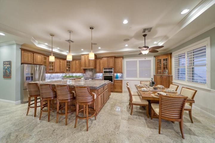 Oversized breakfast counter/island work station in kitchen perfect for entertaining your guest while capturing the views of the Gulf! From the gourmet chef to the casual entertainer- you will find a fully equipped state-of-the-art kitchen with outstanding storage, gleaming granite counters, and extensive specialized lighting!