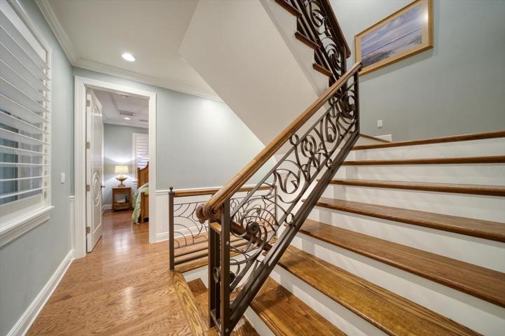 Hand crafted stairs lead to bedrooms and media area.