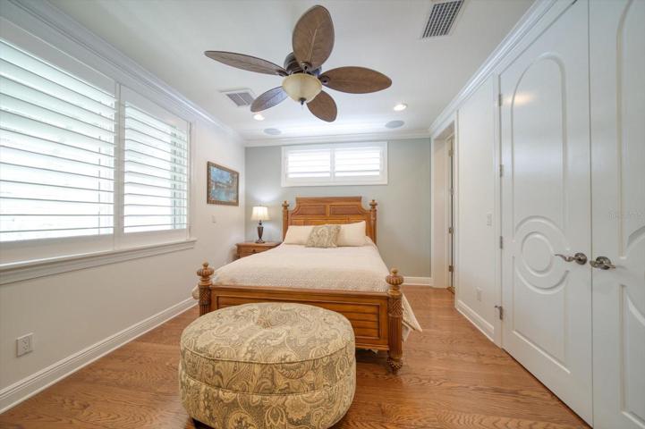 Additional guest bedroom with attractive plantation shutters, gorgeous flooring and private bathroom!