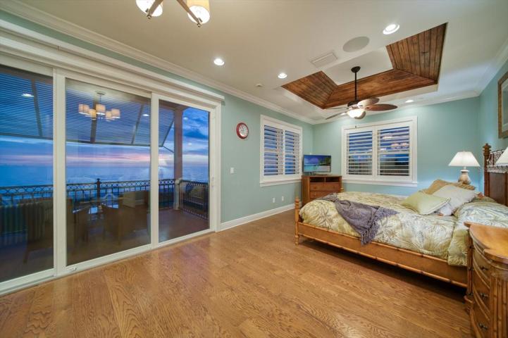 Primary bedroom enjoys a very private balcony, and attractive wood flooring. The detailed tray ceiling, electric blinds and plantation shutters....lovely!