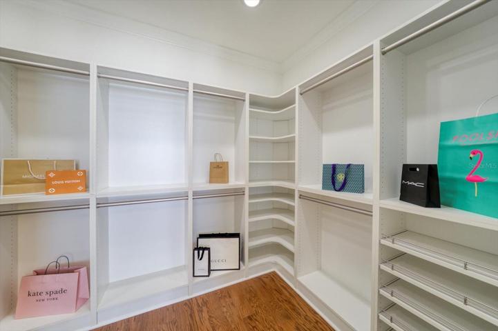 Large walk-in closet of primary suite.