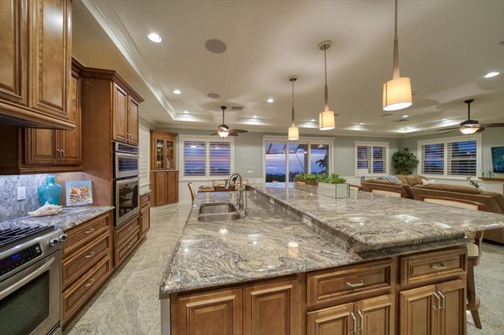 Top of the line appliances including oversized gas range, and bilevel center island.
