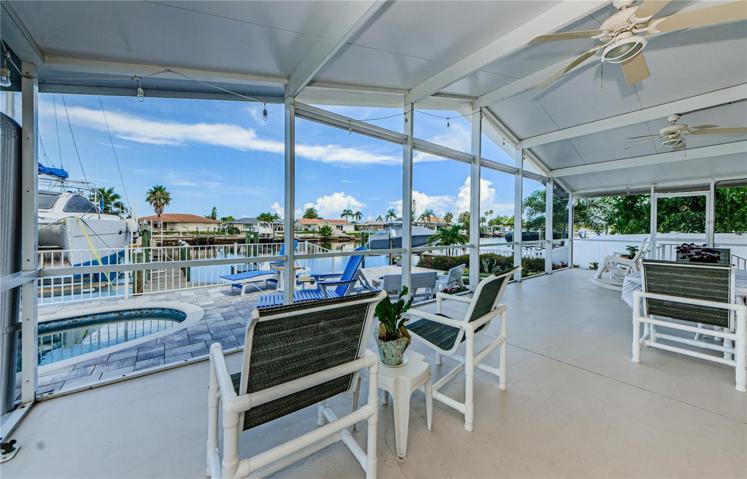 large screened in back porch over looking pool and water