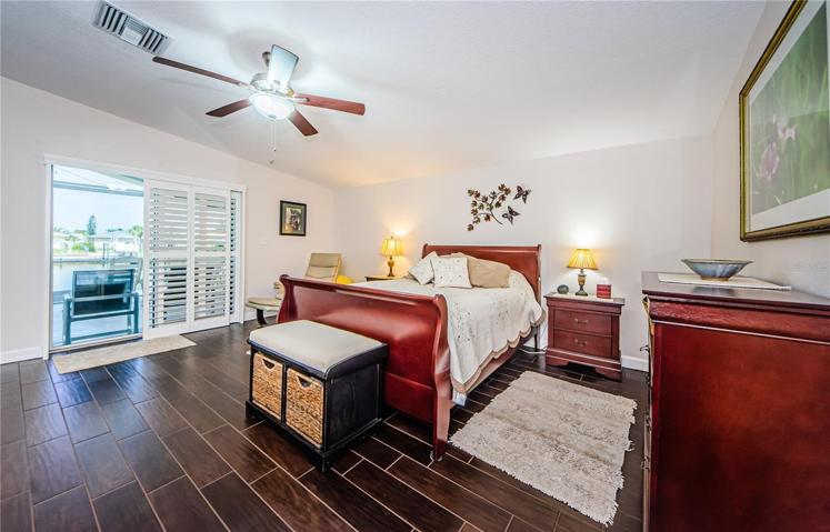 master bedroom with sliding glass doors to the screened porch
