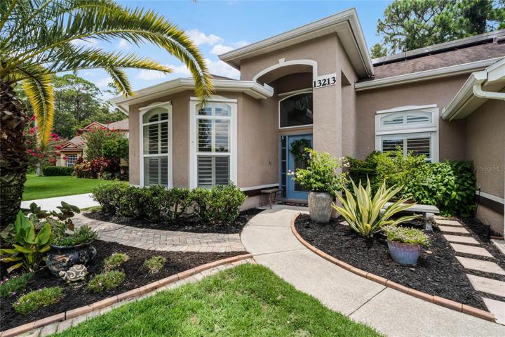 Welcome to your new Waterford Lakes home with a MUST SEE BACKYARD and your own personal secret garden - CONSERVATION VIEWS - .33 ACRE LOT - paver patio, pergola, SUMMER KITCHEN, fruit trees and MORE!