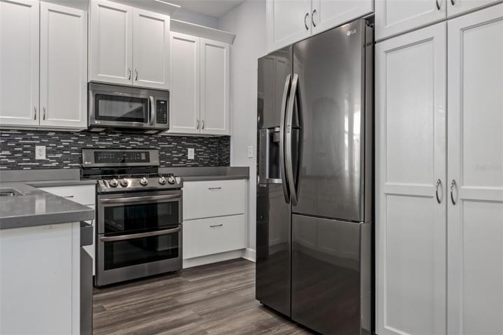 6412 91 Avenue East, Parrish, FL 34219 MLS # A4578299 Ancient OaksStainless appliances, white cabinets, solid counter tops and gas stove