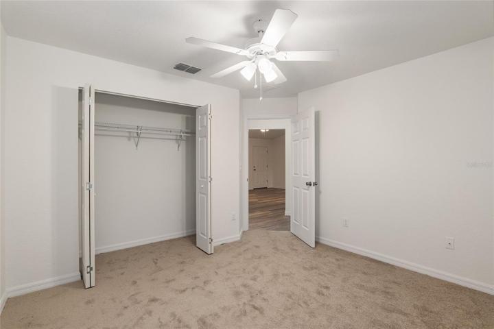 Bedroom 3 with ceiling fan and carpet