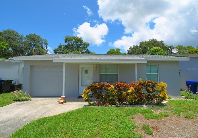Welcome to the Woodbrook Manor community, where this beautiful home awaits you! Upgraded with a new roof in 2019, this home welcomes you with its maintained landscaping and inviting seating area at the front porch.