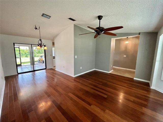 Living room and dining room. Front door is to the right where the opening is