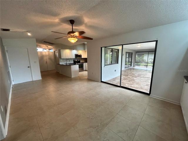 Great/family room looking back to the front entry and kitchen. The door is access to the garage