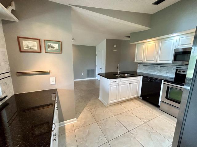 Another view of the kitchen with plenty of counter space and storage