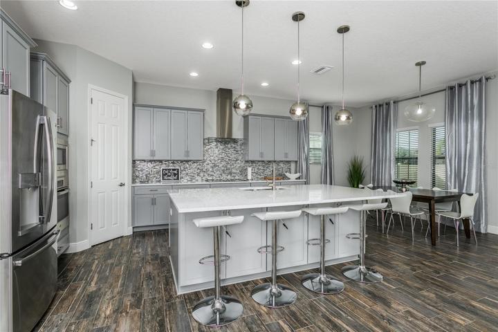 Gourmet kitchen with QUARTZ countertops and upgraded gourmet cabinets. LARGE WALK-IN PANTRY, too!