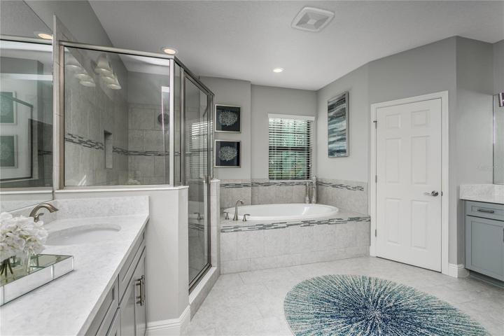 HUGE Master bath with QUARTZ countertops, separate vanities, private lavatory, walk-in shower and garden tub.