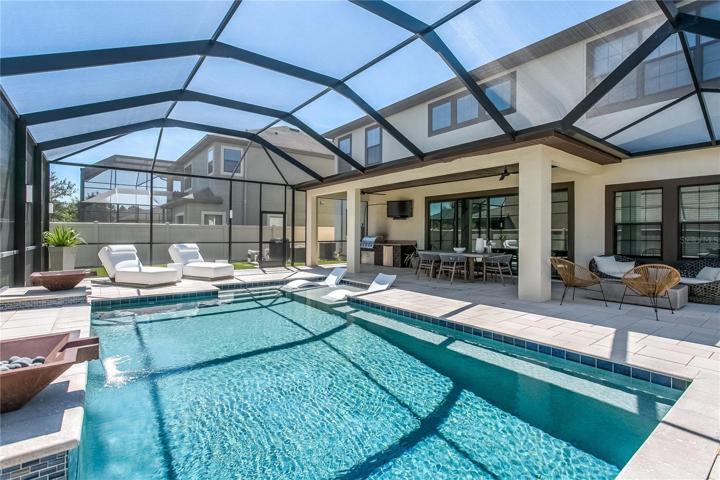 NEW CUSTOM POOL w/large sun shelf, waterfall feature, artistic pavers, and extended, covered/screened lanai (2022–$87k)