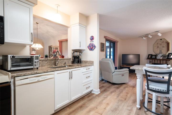 Kitchen towards family room from garage entrance.
