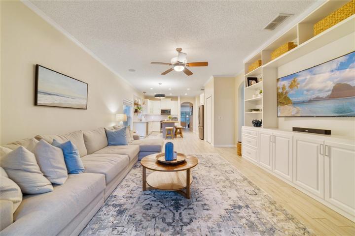 The kitchen opens gracefully to the dinette and generous family room with beautiful built-ins and French door access to the lanai, creating a warm and inviting ambiance!