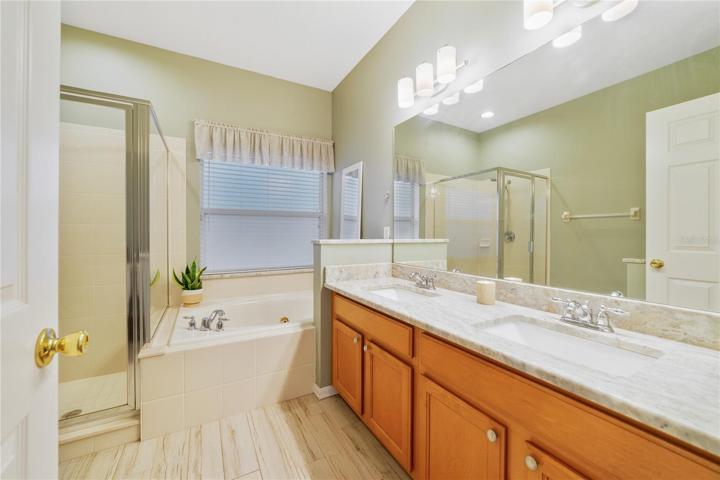 Your private bathroom features a SOAKING TUB, walk-in shower, and extended DOUBLE SINK vanity with GRANITE COUNTERS to start and end your day with ease!