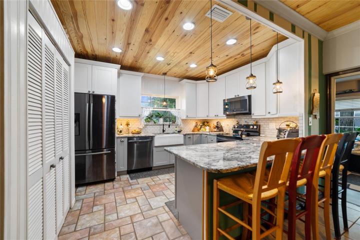 The FULLY REMODELED KITCHEN (2021) is a dream, made to accommodate the chef of the family's culinary needs with NEW STAINLESS STEEL APPLIANCES, subway tile backsplash and breakfast bar seating off the large peninsula!