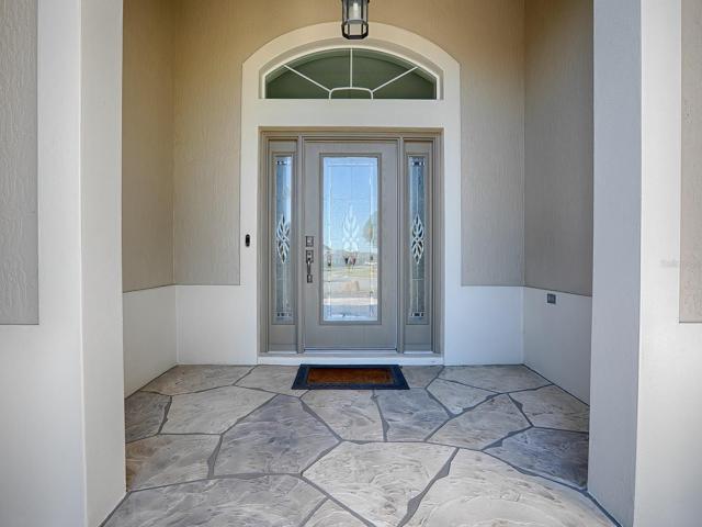 LOVELY ENTRANCE WITH LEADED GLASS FRONT DOOR AND SIDELITES. CONCRETE COATED DRIVEWAY AND WALKWAY.