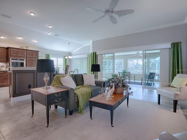 SLIDING GLASS DOORS OPEN OUT TO THE OVERSIZED GLASS ENCLOSED LANAI FROM THE LIVING ROOM AND THE CASUAL DINING AREA!