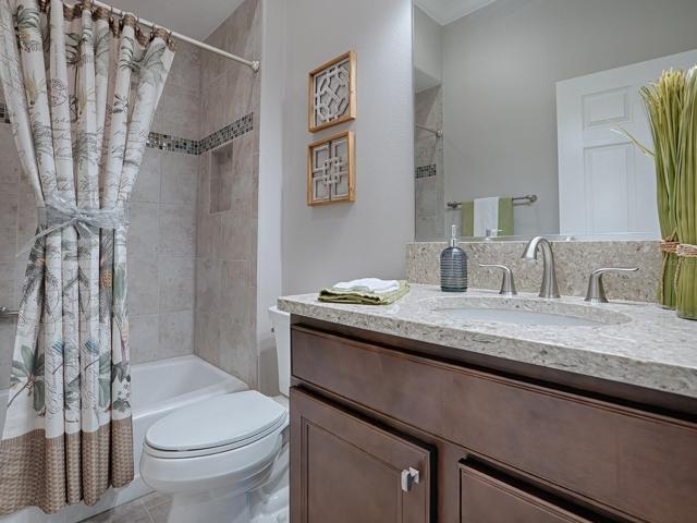 2ND GUEST BATH IS IN THE HALLWAY WITH TILE SURROUND TUB/SHOWER.