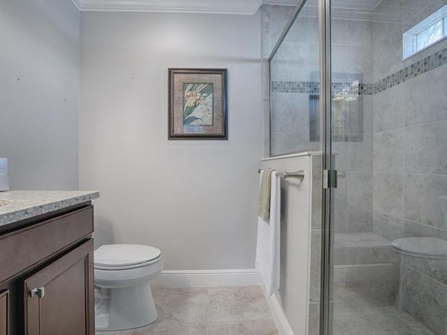 EN-SUITE BATH HAS QUARTZ COUNTER TOPS AND LOVELY TILED SHOWER.