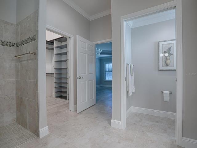 SEPARATE TOILET ROOM WITH POCKET DOOR.