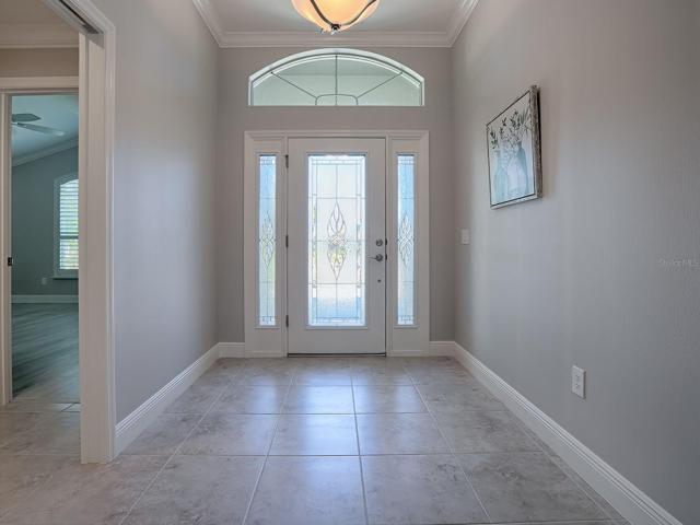 PORCELAIN TILE FLOWS THROUGHOUT THE HOME WITH LAMINATE IN THE BEDROOMS.