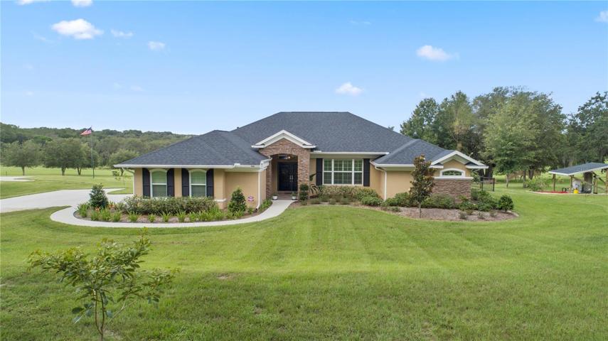 Front exterior built in 2021 sits on 5 acres grass landing strip behind house.