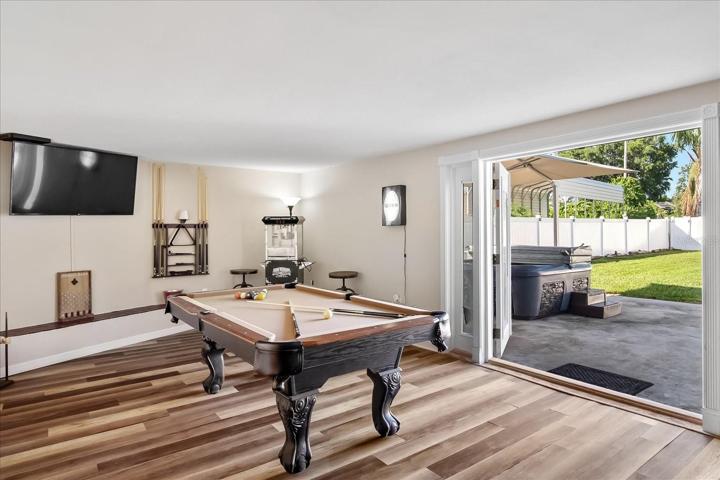 The game room is fun and vibrant with beautiful flooring and double french doors, which open onto the outside patio.