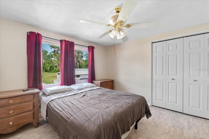 Third bedroom is bright and ready for quests.  With a view of the back yard, you are able to see most of the acre lot.