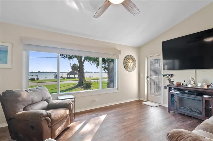 As you enter through the front door, what a view of the lake! Electric blinds will help control any privacy or sunshine concerns and neutral tones, make this a perfect room to be comfortable in.