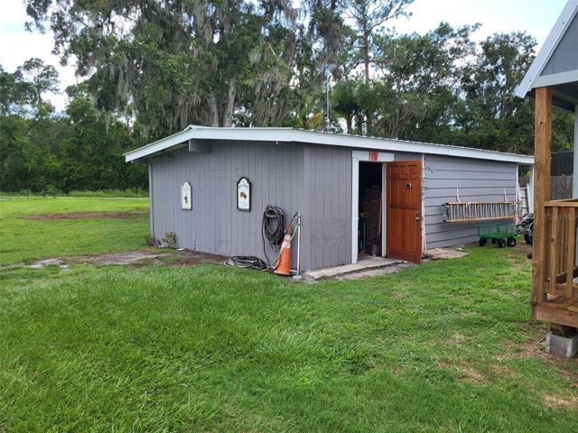 The 3rd shed is an oversized workshop, with a new roof, has shelving and large double doors on the back side.  Notice the huge property and green space.  Lots of room for RV, Semi Truck, Boats, Campers, etc.