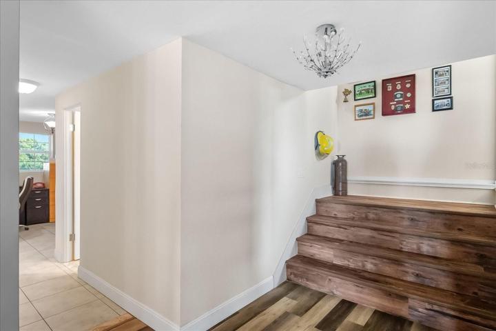 As you step down from the Family room, you enter the 1st Floor. While the ceiling at the top of the steps may be a little low for extremely tall people, it can easily be mitered per the seller.