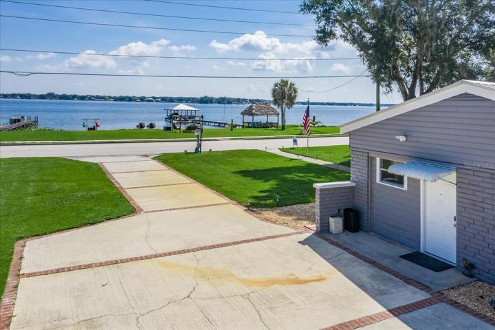 Easy and direct access to the sandy beach, fire pit, kayaks and wave runners, which all convey with the sale of the home.