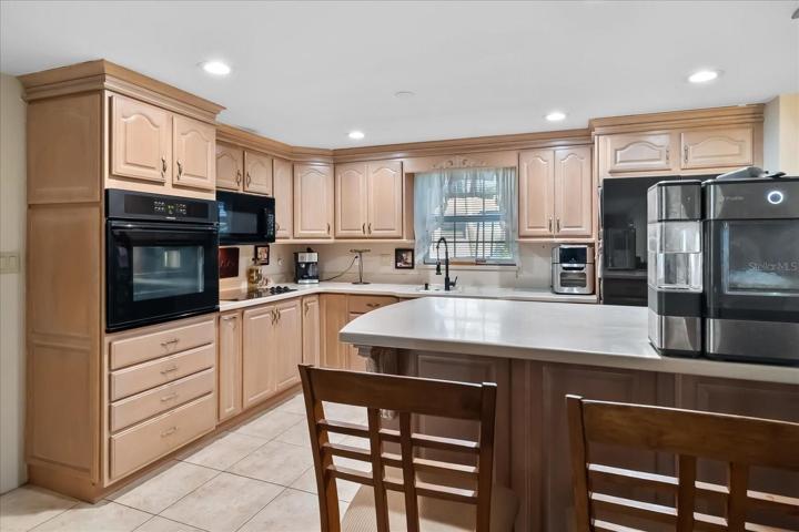 With lots of storage and drawers, you can find room for everything.  Recessed lighting and honey colored cabinets make for a more contemporary look.