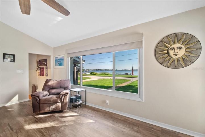 A wonderful view of the front deck, yard and lake front.