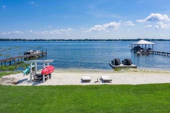White sandy beach, kayaks and wave runners on a floating dock make the perfect recipe for fun in the sun!