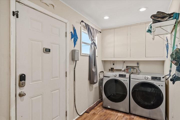 From the office you enter the large laundry room.  The side door gives you outside access to the house.  This way you can go from the backyard or from the lake right into the laundry room for clean up.  The downstairs bedroom is to the right.