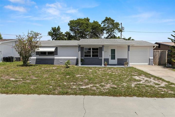 Welcome Home!  2 bed/2 Bath block home with one car attached garage, storm door...and notice the extra parking in the front of the home!