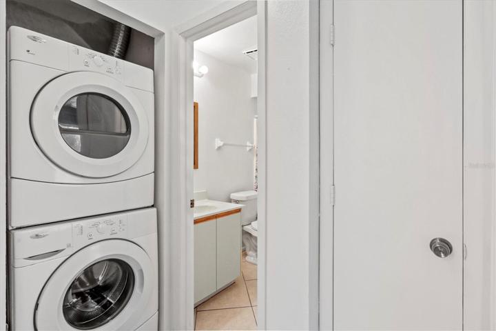 2nd bathroom with stacked washer / dryer and storage closet