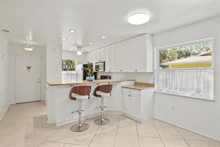 Open floorplan with breakfast bar height counter