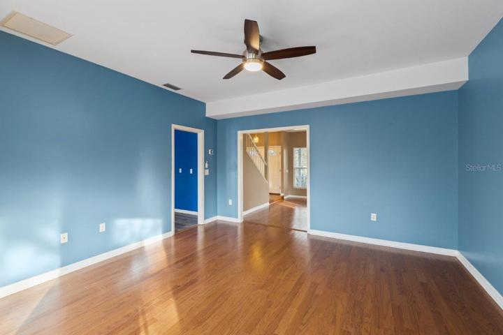 Spacious Family Room featuring Wood flooring, extended bay windows, and direct access to the screened-in lanai