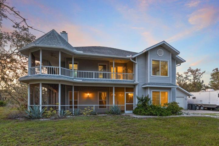 The front elevation showing the wrap around porch on both levels, and the attached two car garage.