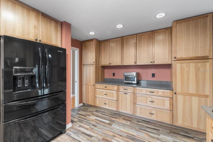 Gourmet Kitchen featuring wood cabinets, polished quartz counter tops, a stainless steal farmhouse sink, and a 36