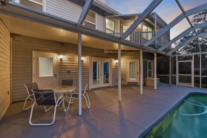 Spacious Screened-in lanai featuring a heated saltwater pool and spa, and out door shower.