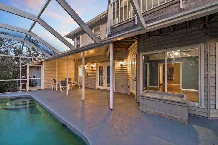 Spacious Screened-in lanai featuring a heated saltwater pool and spa, and out door shower.